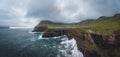 Aerial drone panorama of Gasadalur village and Mulafossur its iconic waterfall, Vagar, Faroe Islands, Denmark. Rough see