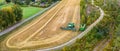 Aerial drone panorama shot of combine harvester in action on small wheat field side, unloading grains. Countryside, Sweden. Wheat Royalty Free Stock Photo