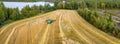 Aerial drone panorama shot of combine harvester, harvesting at the corner of small wheat field, on the countryside, Sweden. Wheat Royalty Free Stock Photo
