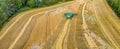 Aerial drone panorama shot of combine harvester, harvesting at the corner of small wheat field, on the countryside, Sweden. Wheat Royalty Free Stock Photo