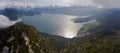 Aerial drone panorama of the Walchensee with Herzogstand and Berggasthaus and Herzogstandbahn on sunny day with clouds in Upper