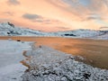 Aerial drone panoramic view. Beautiful sunset over the mountains and sea of the Lofoten Islands. Reine, Norway. Winter landscape w Royalty Free Stock Photo