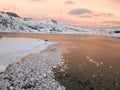 Aerial drone panoramic view. Beautiful sunset over the mountains and sea of the Lofoten Islands. Reine, Norway. Winter landscape w Royalty Free Stock Photo