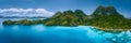 Aerial drone panoramic view of uninhabited tropical island with rugged mountains, rainforest jungle, sandy beaches Royalty Free Stock Photo
