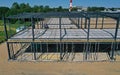 Aerial drone perspective view on steel construction frame, on building site, concrete floor with metal pipe supports and brick Royalty Free Stock Photo