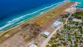 Aerial drone photo of the airport runway area at the tropical island Maamigili at the indian ocean Royalty Free Stock Photo