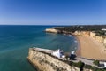 Aerial drone photo of the beaitiful Praia da Senhora da Rocha Senhora da Rocha Beach with the white chapel on the roks, near Arm