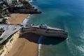 Aerial drone photo of the beaitiful Praia da Senhora da Rocha Senhora da Rocha Beach with the white chapel on the roks, near Arm