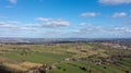 Aerial drone photo of the beautiful town of Thornton in Bradford in the UK showing the farmers fields in the Spring time on a hot Royalty Free Stock Photo