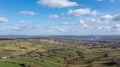 Aerial drone photo of the beautiful town of Thornton in Bradford in the UK showing the farmers fields in the Spring time on a hot Royalty Free Stock Photo