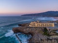 Aerial drone photo of Praia do Guincho Beach and Hotel Fortaleza at sunset in Sintra, Portugal