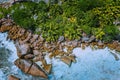 Aerial drone photo of stony boulders of beautiful Anse Cocos beach at La Digue, Seychelles