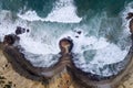 Aerial drone photo of the waves crashing against the rocks in the beautiful coastline along the Vicentine Coast, near the Bordeira Royalty Free Stock Photo