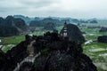 Aerial drone photo - Woman next to a shrine atop a mountain in northern Vietnam. Hang Mua