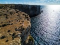 Drone photo - A woman atop the cliffs of Comino Island, Malta