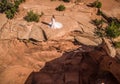 Aerial drone photo - Woman in a wedding dress overlooking a sinkhole in the Utah desert. Royalty Free Stock Photo