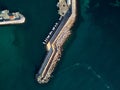 Aerial drone point of view pier mole breakwater and turquoise green water