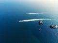 Aerial drone pov top view two coast border guard boat ships sailing fast in clean blue ocean or sea water on bright Royalty Free Stock Photo