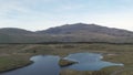 Aerial drone reveal shot of Llyn Dywarchen with Yr Wyddfa in the background