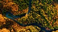 Aerial drone`s view of forest road in the mountains. Colourful landscape with rural road, trees with yellow leaves Royalty Free Stock Photo