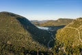 Aerial drone shot of City Wall of Ston over hill with view of Salt Pan in Croatia sunrise