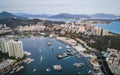 Aerial drone shot cityscape of Sanya city with marina and buildings Hainan island China