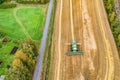 Aerial drone shot of combine harvester, harvesting in a middle of small wheat field, on the countryside, Sweden. Wheat field is Royalty Free Stock Photo