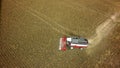 Aerial drone shot of a combine harvester working in a field. Tractors and farm machines harvesting corn in Autumn Royalty Free Stock Photo