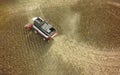 Aerial drone shot of a combine harvester working in a field. Tractors and farm machines harvesting corn in Autumn Royalty Free Stock Photo