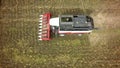 Aerial drone shot of a combine harvester working in a field. Tractors and farm machines harvesting corn in Autumn Royalty Free Stock Photo