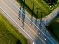 Aerial drone shot of the cyclists racing on the open road