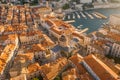 Aerial drone shot of Dubrovnik Cathedral in repair with old port in Croatia sunrise hour