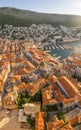 Aerial drone shot of Dubrovnik Cathedral in repair with old port in Croatia sunrise hour