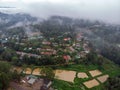 Aerial Drone Shot Flying by Cloudy Misty Foggy Lushoto village in Usambara Mountains. Remote Place in Tanga Province Royalty Free Stock Photo