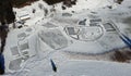 Aerial drone shot of frozen lake in winter with ice skaters Royalty Free Stock Photo