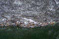 Aerial drone shot of Hallstatt village snow covered by snow houses by lake during winter time in Austria Royalty Free Stock Photo