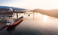 Aerial drone shot of a industrial shipyard and cargo ship loading port with cargo ships in Vancouver, BC, Canada. Royalty Free Stock Photo