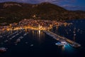 Aerial drone shot of Komiza town port in night with city light on Vis Island in Croatia summer dusk