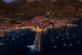 Aerial drone shot of Komiza town port in night with city light on Vis Island in Croatia summer dusk