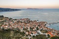 Aerial drone shot of Komiza village on Vis Island in Croatia during sunrise with view of Bisevo island in summer Royalty Free Stock Photo