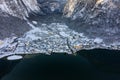 Aerial drone shot of Lahn village covered by snow by Hallstatt lake in Austria during winter Royalty Free Stock Photo