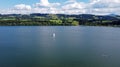 Aerial drone shot of lake with sailboats and stand up paddler Royalty Free Stock Photo