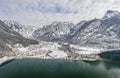 Aerial drone shot of Obertraun village in snow mountain valley by Hallstatt lake in Austria in winter Royalty Free Stock Photo