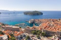 Aerial drone shot of Otok Lokrum in Dubrovnik in with port view in Croatia summer morning