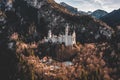 Aerial drone shot of picturesque Neuschwanstein Castle on snowy hill in winter sunlight in Germany Royalty Free Stock Photo
