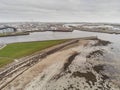 Aerial drone shot of South Park and Nimmo`s pier. Galway bay beach, low tide, City and industrial port building in the background Royalty Free Stock Photo