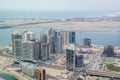 Aerial drone shot of towers and skyscrapers under construction around the sea - Al Reem Island, Abu Dhabi