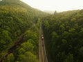 Aerial Drone shot of truck driving down a road in the misty Adirondack Mountains.