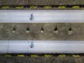 Aerial drone shot of two bike rining trough the park