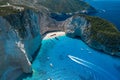 Aerial drone shot of Zakynthos Navagio beach with tourists with cruise ship in blue Ionnian sea